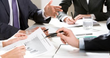 Close-up of businessman explaining a financial plan to colleagues at meeting