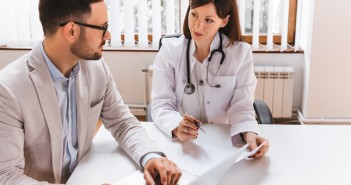 Businessman talking with female doctor at the hospital